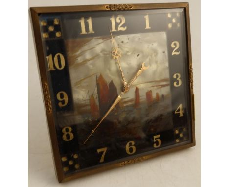 A mantle clock, decorated with ships and dice to the corners, with easel support