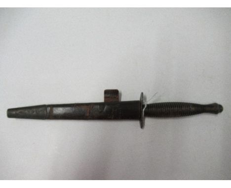 A World War II Commando fighting knife, or dagger, with ribbed handle, and sheath