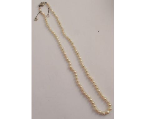 A graduated cultured pearl single strand necklace, with an old and single cut diamond set lozenge shaped clasp, length 48cm