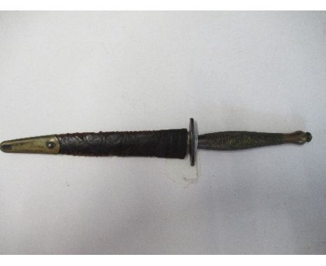 A World War II Fairbairn Sykes style Commando dagger, together with sheath, with blade by Wilkinson, sheath having striations
