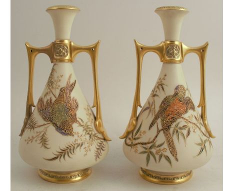 A pair of Royal Worcester Persian style two handled gilded ivory vases, decorated with shot silk birds, restored, height 10in