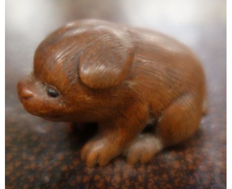 A Japanese carved netsuke, of a stylised animal. width 1.5ins