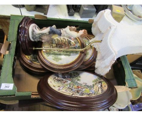 A collection of collectors plates and a lamp