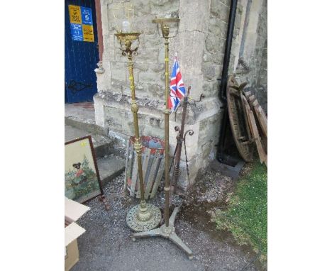 Two brass lamp standards, together with a stand