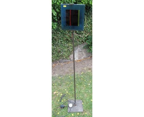 A floor standing lamp, with coloured glass panel
