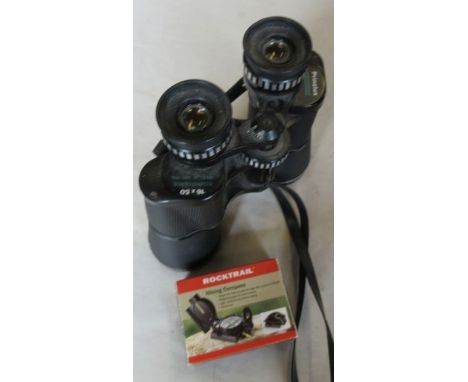A Hiking compass together with a pair of binoculars&nbsp;