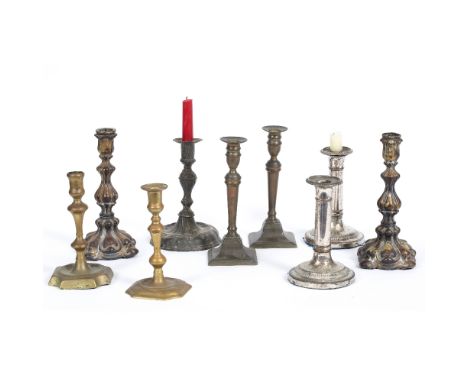 A PAIR OF ROCOCO STYLE SILVERED PRESSED BRASS CANDLESTICKS 22cm high together with a pewter candlestick with writhen knoped s