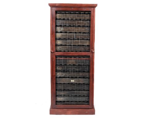 A STAINED PINE FLOOR STANDING APPLE STORE the wired panel to the front enclosing sixteen trays, 71cm wide x 68.5cm deep x 168