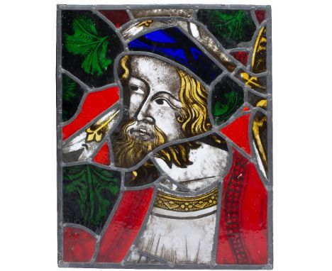 A MEDIEVAL STYLE STAINED GLASS WINDOW PANEL with a head and shoulder portrait of a bearded gentleman, 38.5cm wide x 47.5cm hi