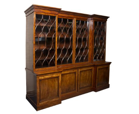 A MAHOGANY LIBRARY BREAKFRONT BOOKCASE with four oval arched glazed doors opening to reveal adjustable shelves above two cent