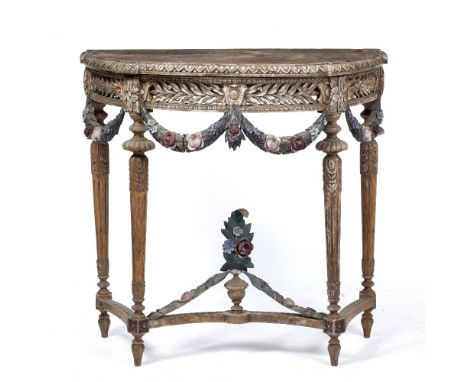 A CONTINENTAL CARVED HARDWOOD D SHAPED SIDE TABLE with pierced laurel carved frieze and painted floral swags on fluted taperi