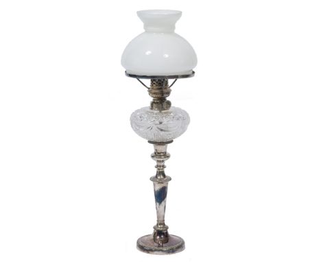 A TABLE LAMP  constructed from a silver plated candlestick and cut glass reservoir and white glass shade 50cm high 