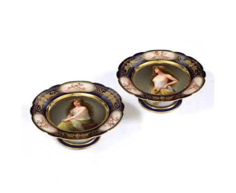 A PAIR OF VIENNA PORCELAIN TAZZA the central royal blue ground border with gilt decoration and each with a portrait of a youn