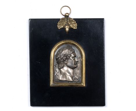 A WHITE METAL PRESSED PROFILE PORTRAIT OF NERO 5cm high set within an ebonised frame, 9.5cm wide x 11cm high
