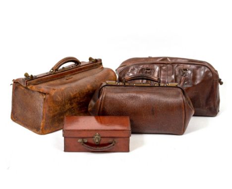 AN ANTIQUE LEATHER GLADSTONE BAG 45.5cm wide together with a further smaller similar bag, leather holdall and small leather c