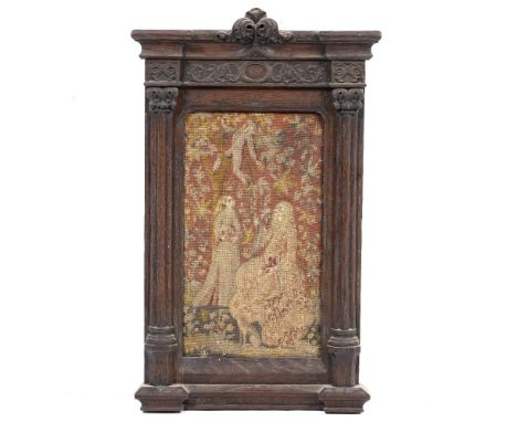 AN ANTIQUE TAPESTRY PANEL depicting two courtly figures being handed fruit from a tree, set within an antique carved oak fram