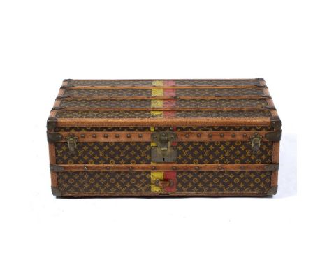 A LOUIS VUITTON LOW LEATHER AND ASH TRAVELLING TRUNK decorated with Louis Vuitton stamped covering, labelled within and numbe