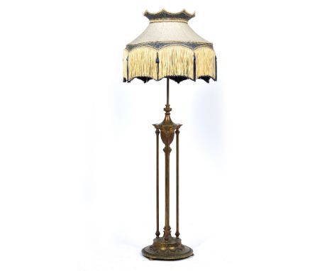AN EARLY 20TH CENTURY GILT METAL ADJUSTABLE LAMP STANDARD later converted for electricity with classical decoration, reeded c