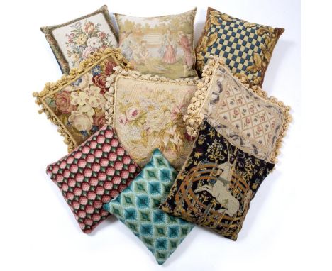 THREE TAPESTRY CUSHIONS with tasselled edges, the largest decorated with flowers, 56cm x 46cm and five further decorative cus