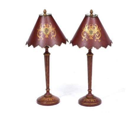 A PAIR OF RED LACQUERED PARCEL GILT TABLE LAMPS with fluted tapering column and circular spreading bases, 16cm diameter x 66c