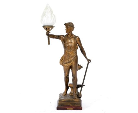 A GOLD PAINTED SPELTER TABLE LAMP in the form of a Blacksmith in classical costume, representing industry, and holding a torc