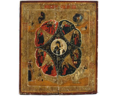 A LATE 19TH / EARLY 20TH CENTURY RUSSIAN ICON centrally painted with a cartouche depicting The Virgin and Child surrounded by