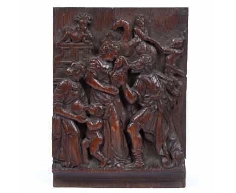 AN 18TH CENTURY CARVED OAK PANEL depicting acts of charity, 14cm wide x 19cm high
