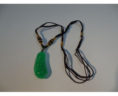 GREEN JADE CARVING ON A SILK THREAD