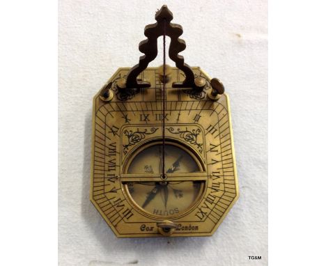 A brass compass and sun dial