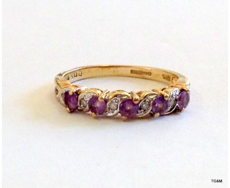 A 9ct gold diamond and amethyst 1/2 eternity ring size N