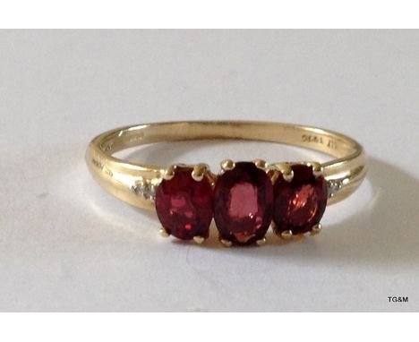 A 9ct gold 3 stone ruby ring size Q