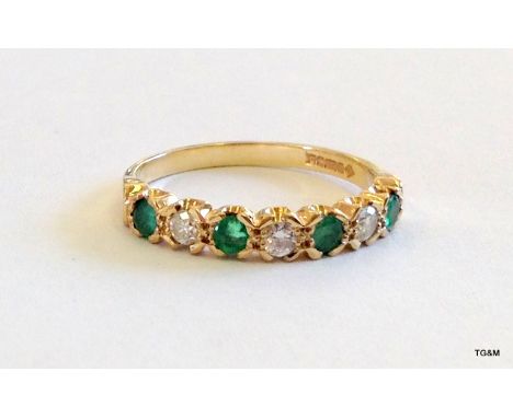 A 9ct gold diamond and emerald 1/2 eternity ring size N