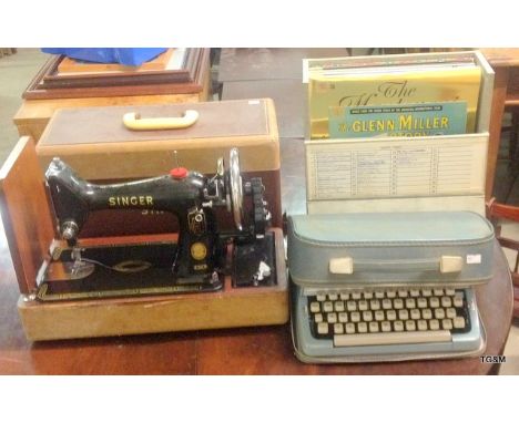 A Brother portable typewriter, singer sewing machine and a collection of records