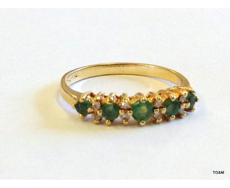 A 9ct gold diamond and emerald 1/2 eternity ring size K