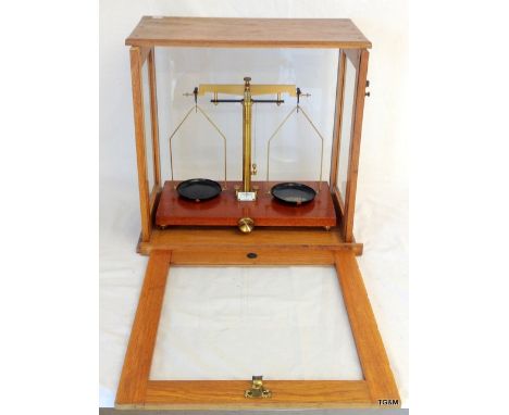 A set of late Victorian precision scales in a light oak glazed case by Eureka - London