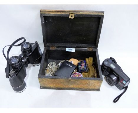 An eastern brass and copper box with contents, a pair of Bell and Howell binoculars and a camera