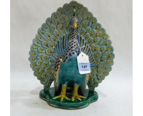 A ceramic model of a peacock, brightly painted in coloured enamels and gilded. 11½'' high
