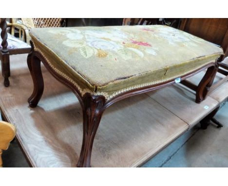 A Victorian walnut stool with tapestry seat on French cabriole legs. 37'' wide