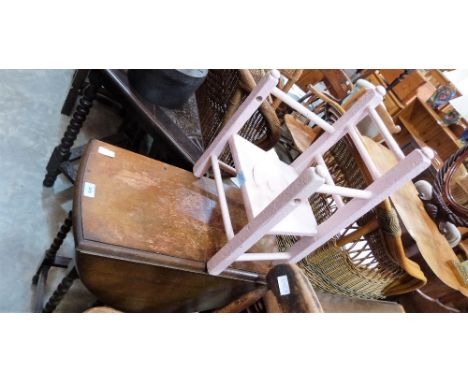 An oak gate leg table on bobbin turned legs and a painted child's commode chair