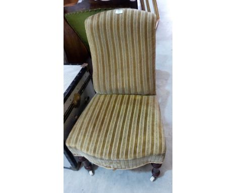 A Victorian nursing chair on turned walnut legs with ceramic castors
