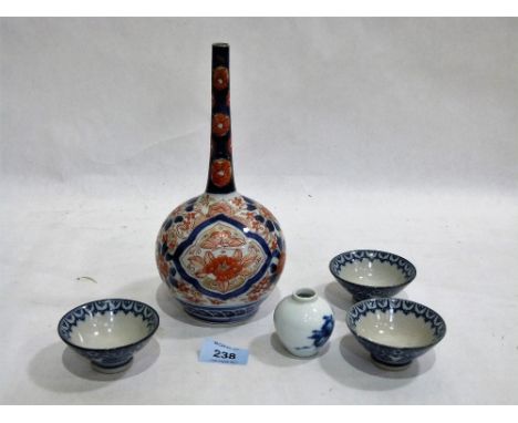 A Japanese Imari decorated globular vase, 9¼'' high; three blue and white saki cups and a miniature blue and white vase