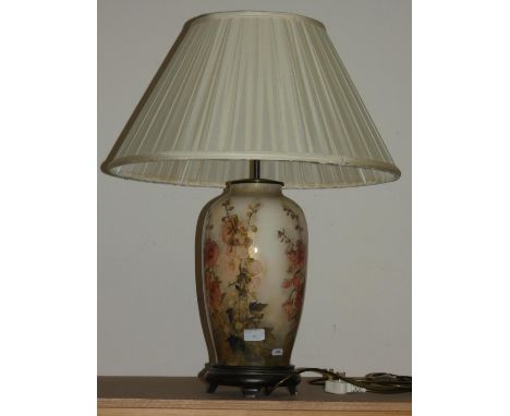 A floral ceramic table lamp with fabric shade. 