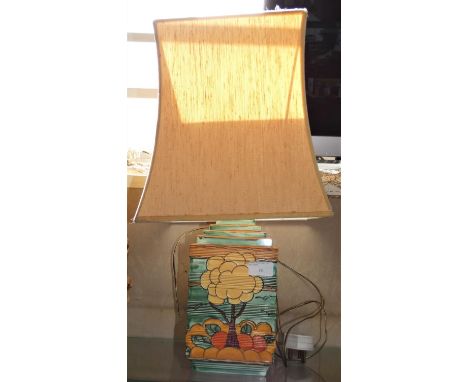 An Art Deco style table lamp, tubeline decorated with trees on a green ground, signed 'Poole' and '561' to the base, height w