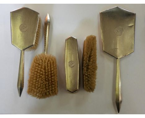 A four piece silver dressing table set, Birmingham 1930, with engine turned decoration. 