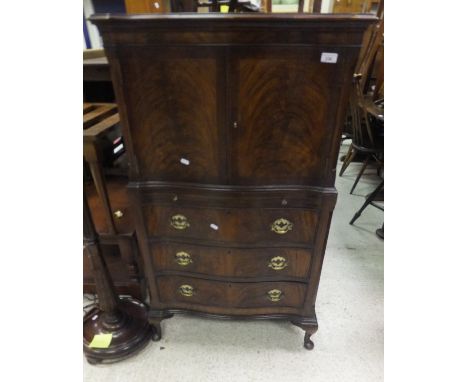 A mahogany serpentine fronted cabinet, the two cupboard doors above a brushing slide, above three long drawers, together with