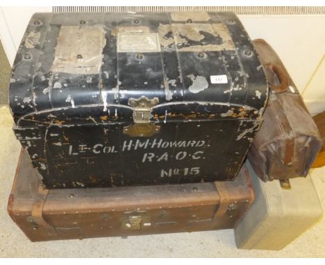 A black painted metal trunk inscribed "Lt Col Howard R.A.O.C.", together with a canvas covered trunk, a brown leather briefca