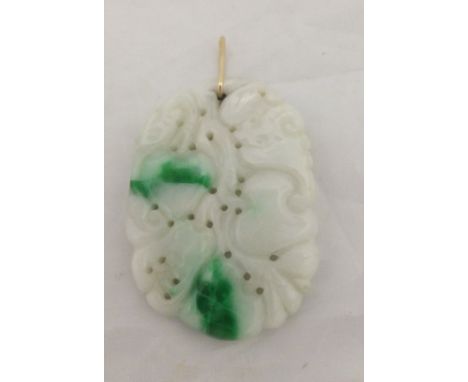 A carved jade pendant depicting various animals on fruit to include bat and lizards