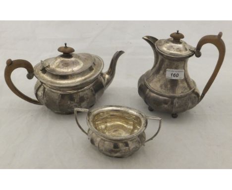 A George V silver three piece tea set of stylised squash form comprising teapot, hot water jug and sugar basin (by Adie Broth