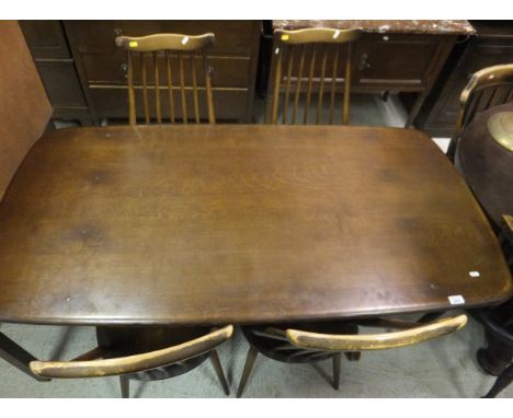 An Ercol rounded rectangular refectory style dining table, a set of four Ercol stick back dining chairs, and a pair of panel 