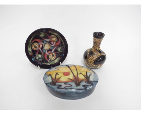 Three pieces of Moorcroft including Land Horse pattern vase, 10cm tall, Reeds at Sunset pattern oval lidded pot and a Celtic 